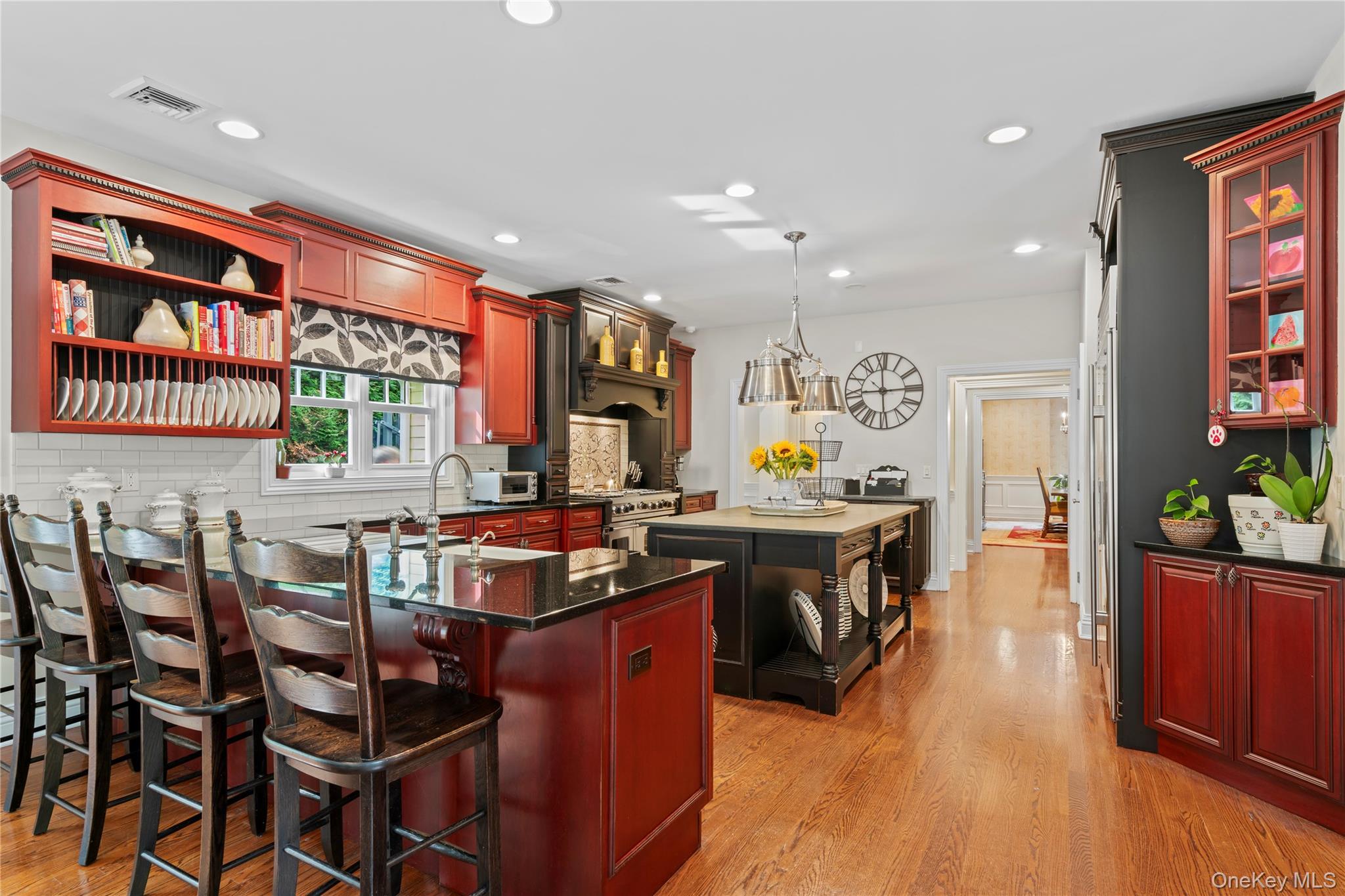 12 Parish Drive Locust Valley, NY 11560 - Photo 13 of 49 a kitchen with stainless steel appliances granite countertop a stove a refrigerator a kitchen island with chairs and wooden floor
