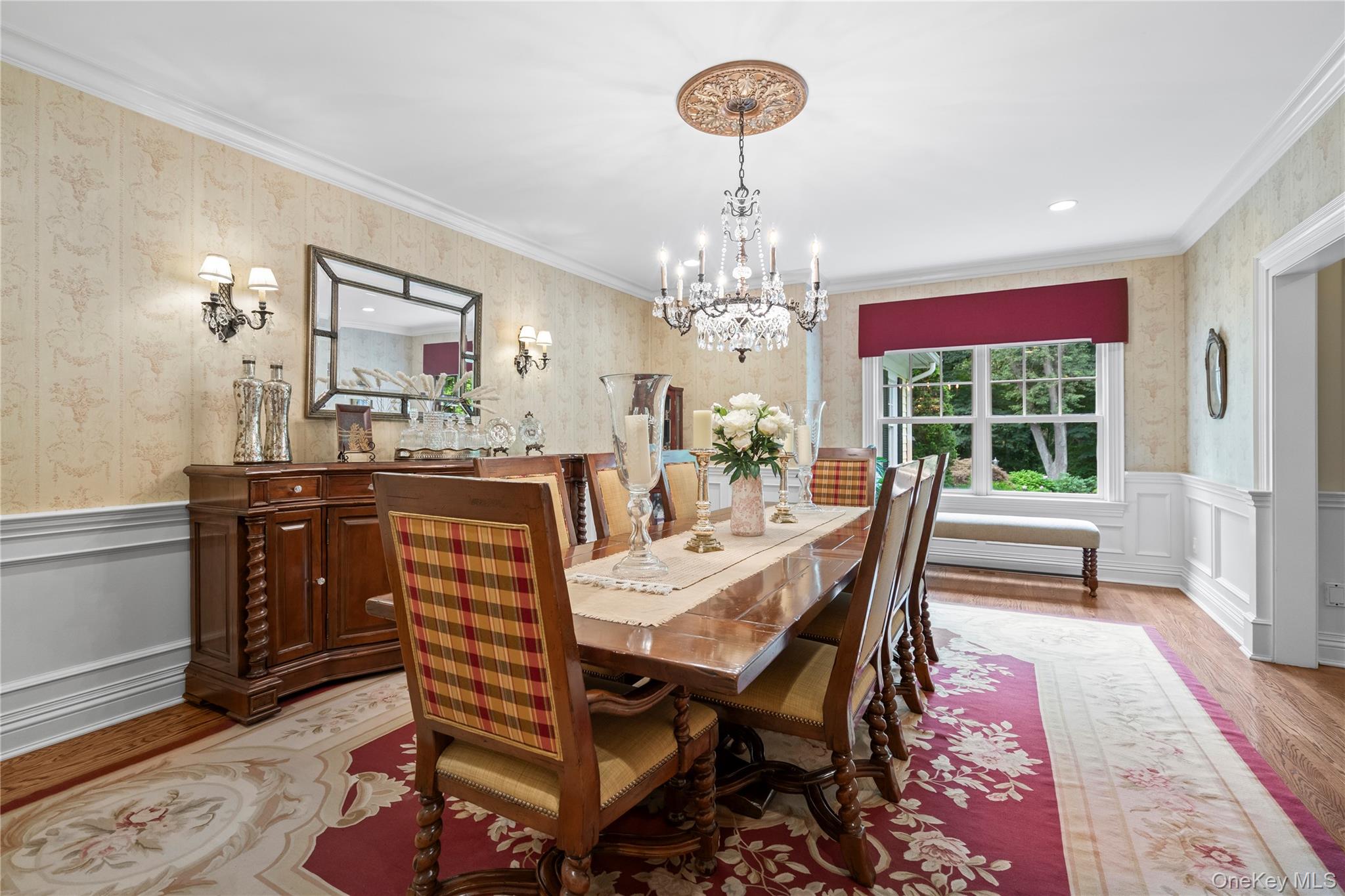 12 Parish Drive Locust Valley, NY 11560 - Photo 18 of 49 a dining room with wooden floor a chandelier a wooden table and chairs