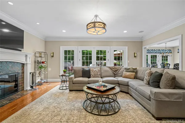 a living room with furniture a flat screen tv and a fireplace