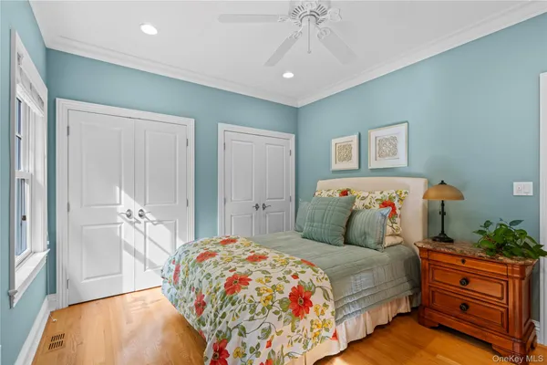 a bedroom with a large bed and a chandelier