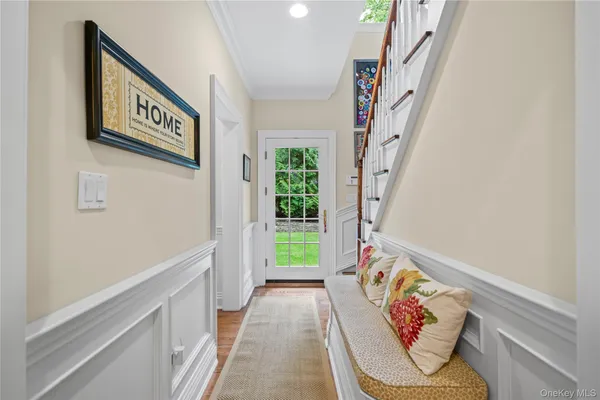 a view of an entryway with wooden floor