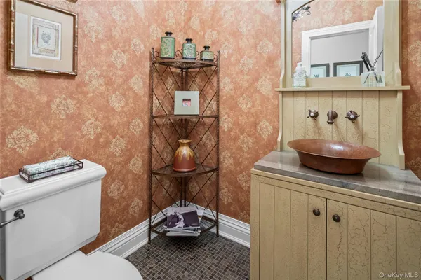 a bathroom with a toilet a sink and mirror