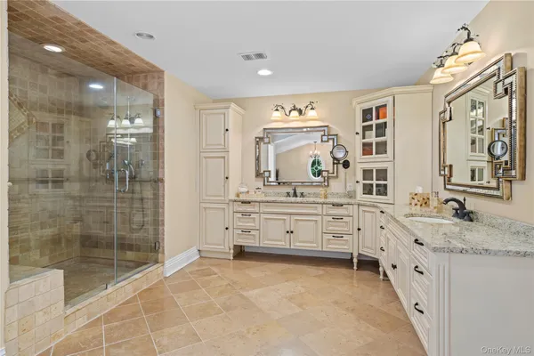 a bathroom with a granite countertop sink mirror and shower