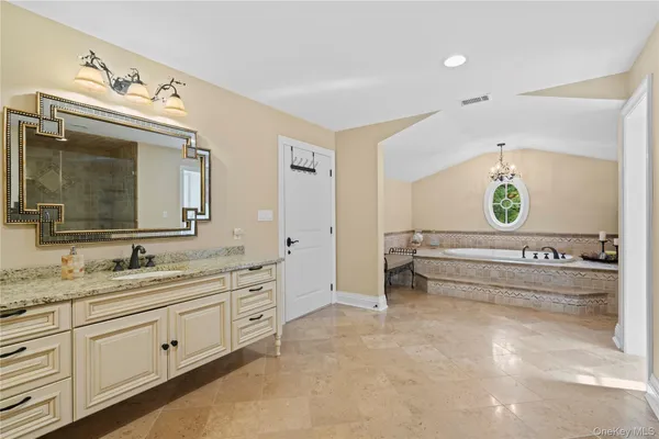 a spacious bathroom with double vanity and a mirror