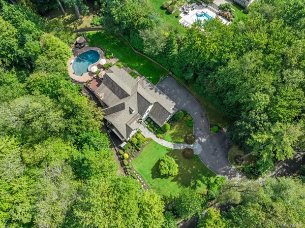 an aerial view of a house with a yard