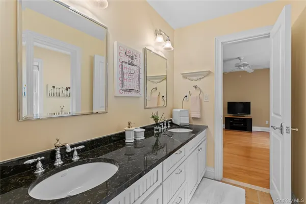a bathroom with double sink and a mirror