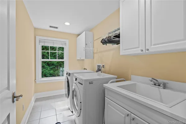 a view of a bathroom with a sink and washing machine