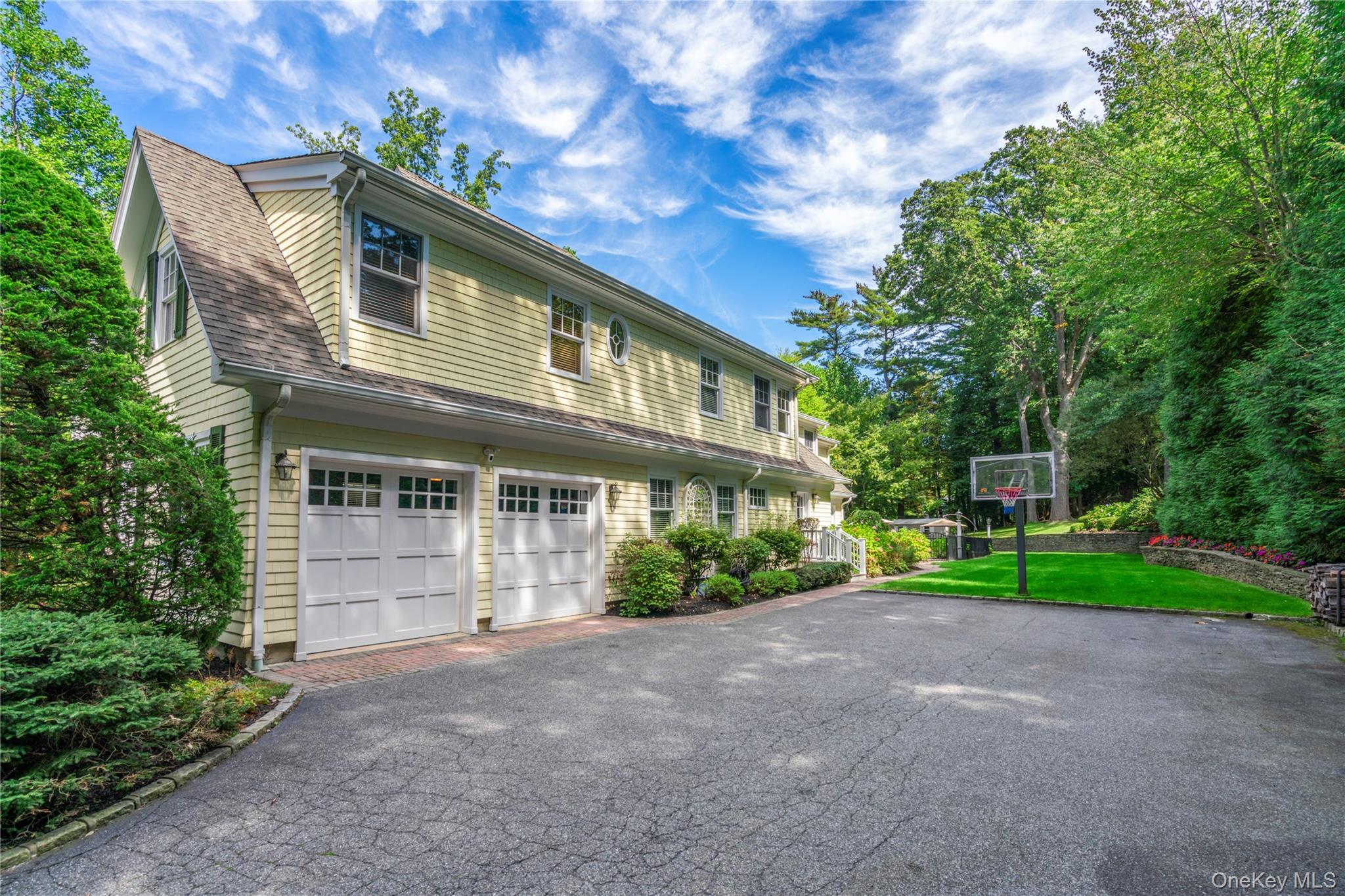 12 Parish Drive Locust Valley, NY 11560 - Photo 40 of 49 a front view of a house with a yard and garage