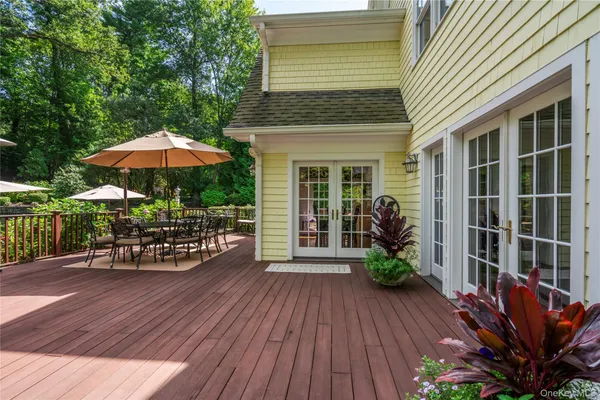 a view of a chairs and table on the wooden deck
