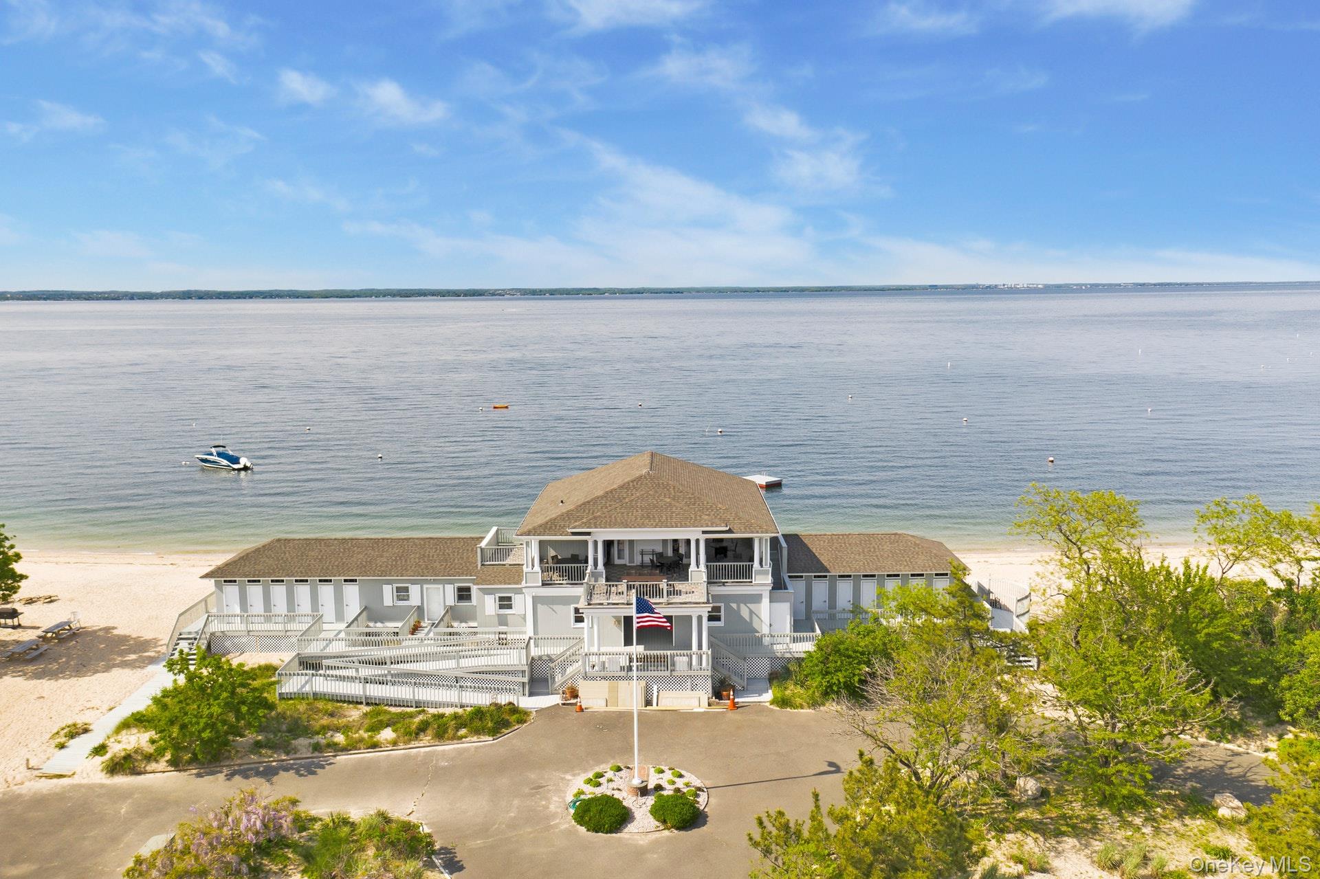 12 Parish Drive Locust Valley, NY 11560 - Photo 44 of 49 a front view of a house with a yard