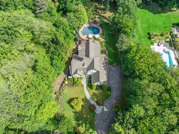an aerial view of a house with a yard basket ball court and outdoor seating