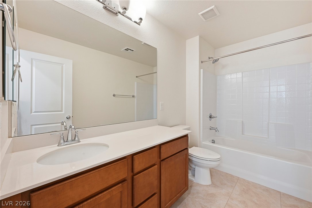 250 Dedication Avenue Henderson, NV 89011 - Photo 38 of 67 Bathroom with bathtub / shower combination, vanity, and light tile patterned floors
