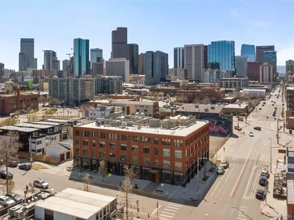 a view of a cars park in front of a building