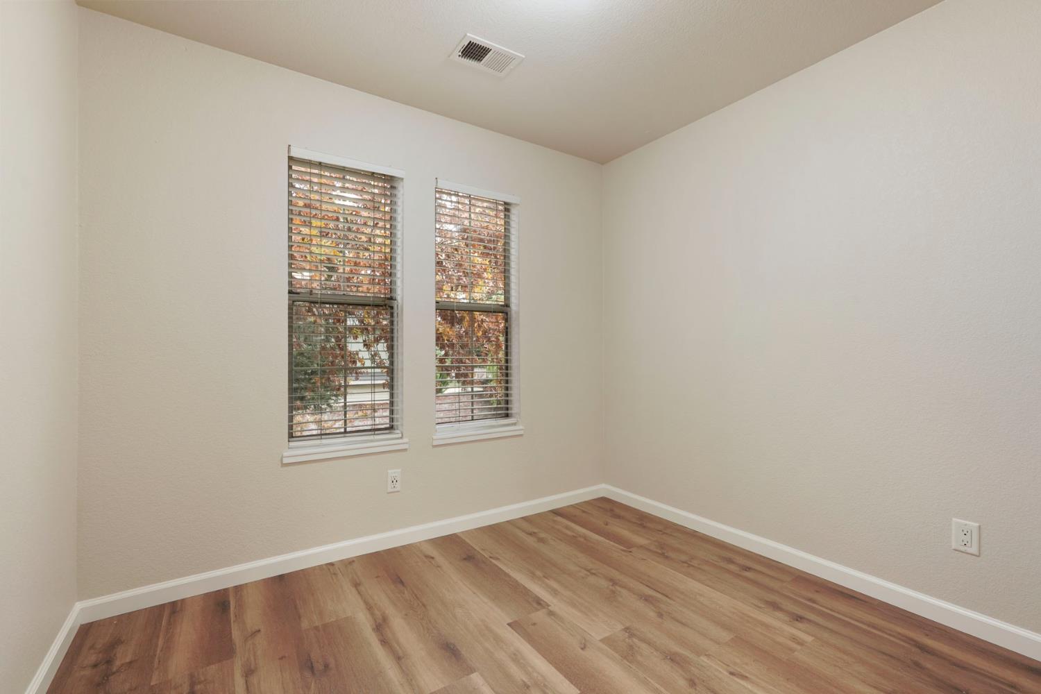2400 Eilers Lane, Unit 1806 Lodi, CA 95242 - Photo 16 of 29 an empty room with wooden floor and windows