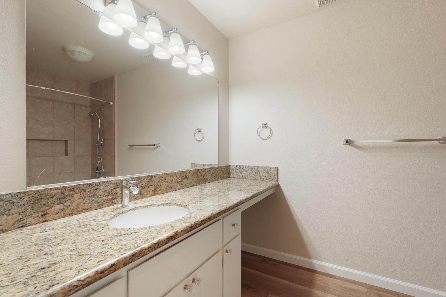 2400 Eilers Lane, Unit 1806 Lodi, CA 95242 - Photo 20 of 29 a bathroom with a granite countertop sink and a mirror