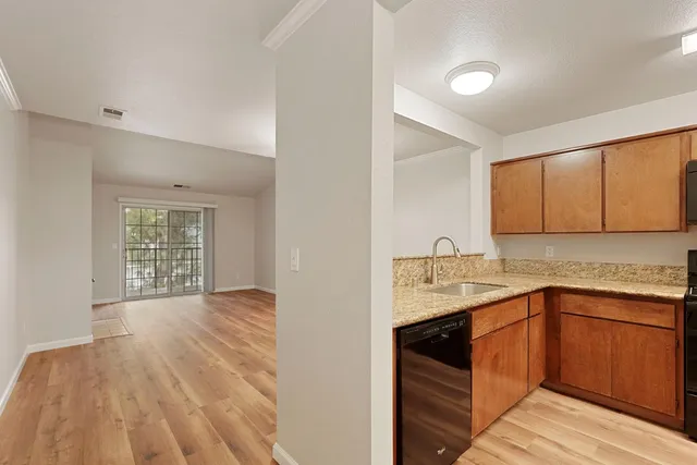 a kitchen with a sink cabinets and window