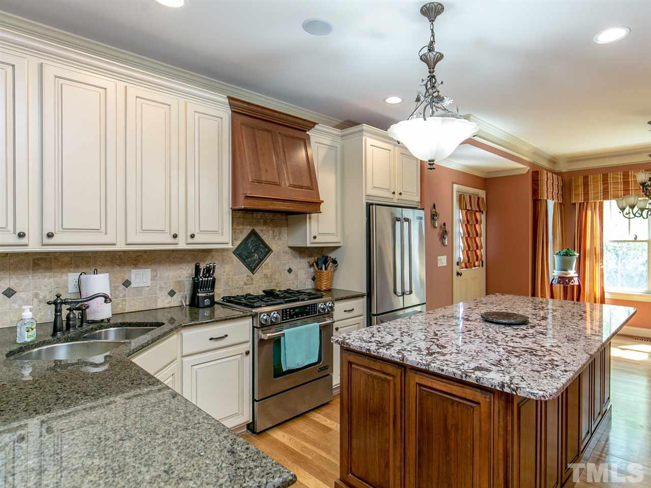 12609 Port Chester Court Raleigh, NC 27614 - Photo 8 of 23 Kitchen offers 2 Toned Cabinets, Granite and Center Island