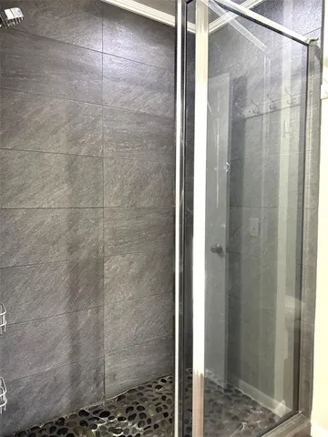 a bathroom with a glass shower door