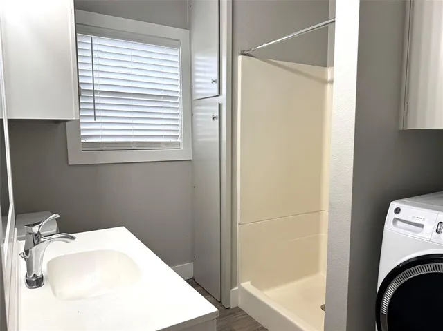 a bathroom with a sink a washer and dryer