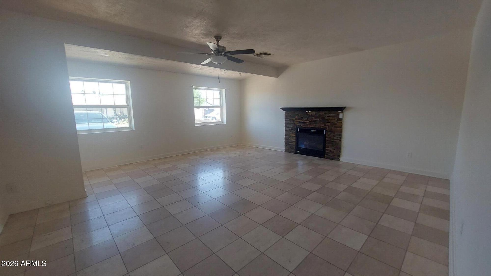 2448 West Freeway Lane Phoenix, AZ 85021 - Photo 5 of 27 an empty room with windows and fireplace