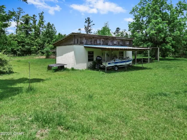 a view of a patio with a table chairs and a backyard