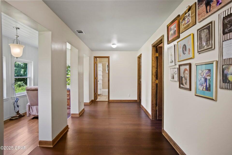 133 Devane Road Chattahoochee, FL 32324 - Photo 18 of 39 a view of a hallway with wooden floor and a living room