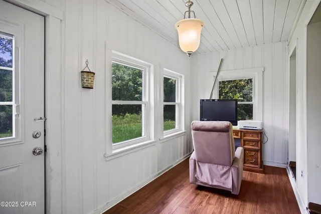 a kitchen with stainless steel appliances granite countertop a sink a stove and microwave with wooden floor
