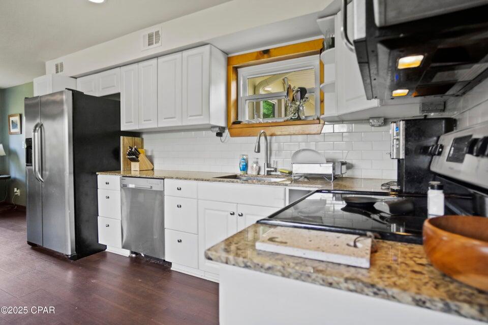 133 Devane Road Chattahoochee, FL 32324 - Photo 23 of 39 a kitchen with stainless steel appliances granite countertop a refrigerator stove microwave and sink