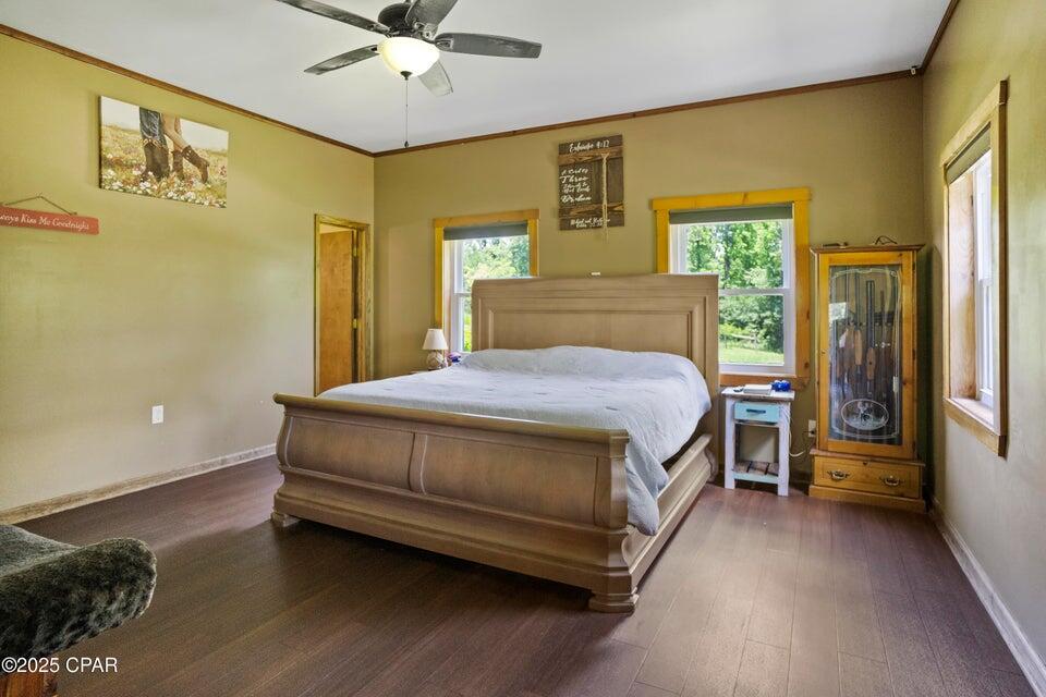 133 Devane Road Chattahoochee, FL 32324 - Photo 34 of 39 a bedroom with a bed and wooden floor