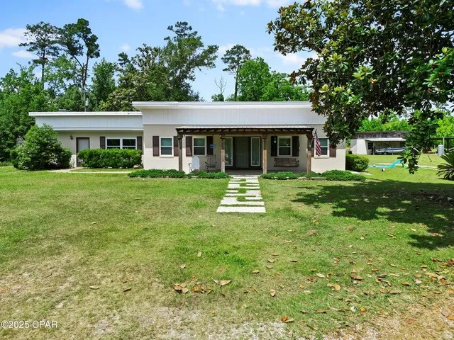 a front view of house with yard and green space