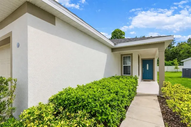 a view of a house with potted plants