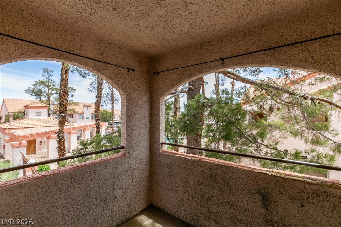 7570 West Flamingo Road, Unit 252 Las Vegas, NV 89147 - Photo 36 of 44 Arched openings frame views of the vibrant community and mature trees from this inviting outdoor space.