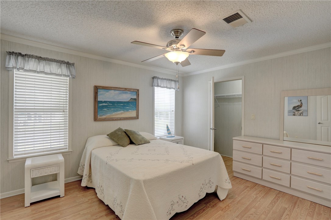9755 61st Terrace Sebastian, FL 32958 - Photo 20 of 35 a bedroom with a large bed and a dresser
