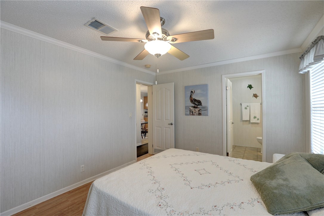 9755 61st Terrace Sebastian, FL 32958 - Photo 22 of 35 a bedroom with a bed and a chandelier