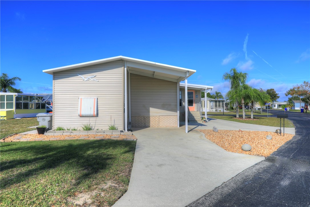 9755 61st Terrace Sebastian, FL 32958 - Photo 3 of 35 a view of a house with swimming pool and a yard