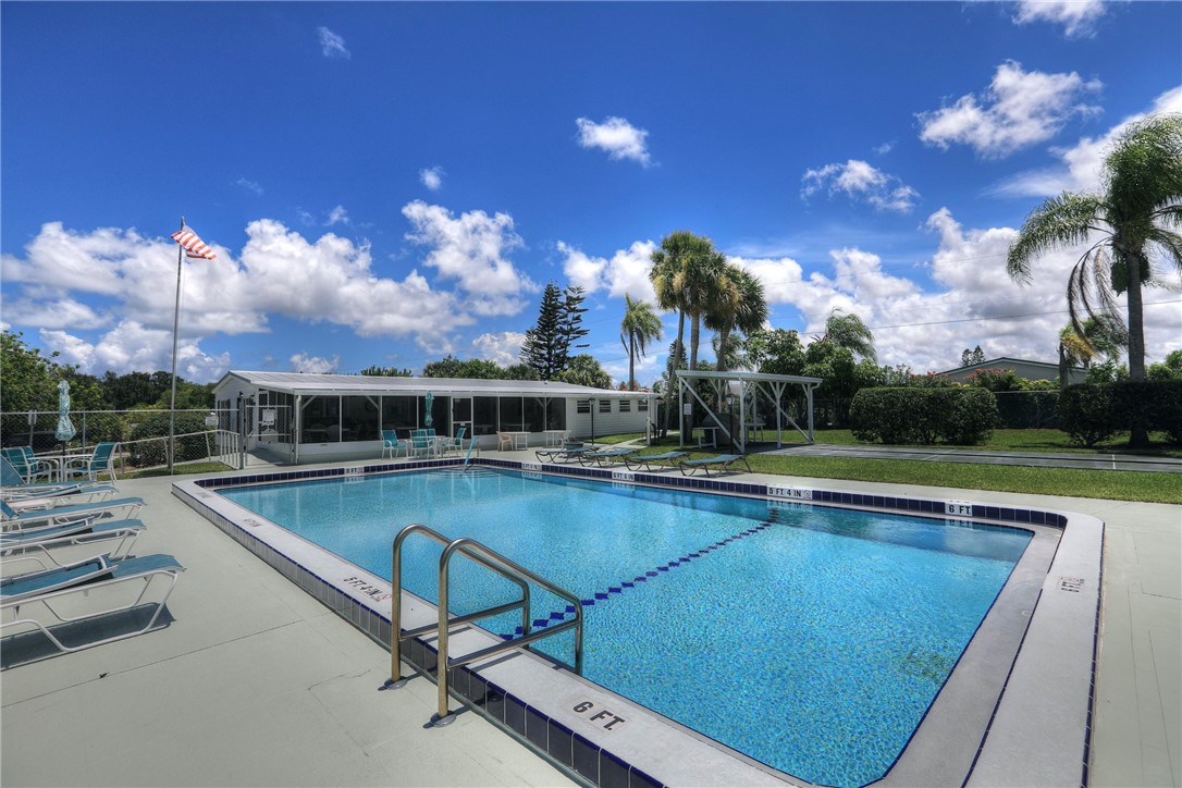 9755 61st Terrace Sebastian, FL 32958 - Photo 32 of 35 a view of a swimming pool with outdoor seating and plants