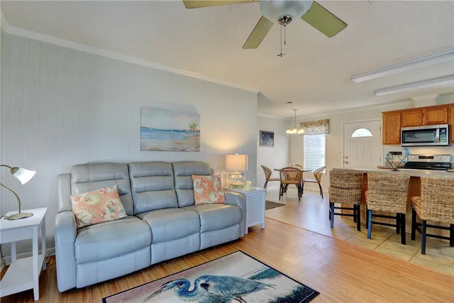 a living room with furniture fireplace and wooden floor