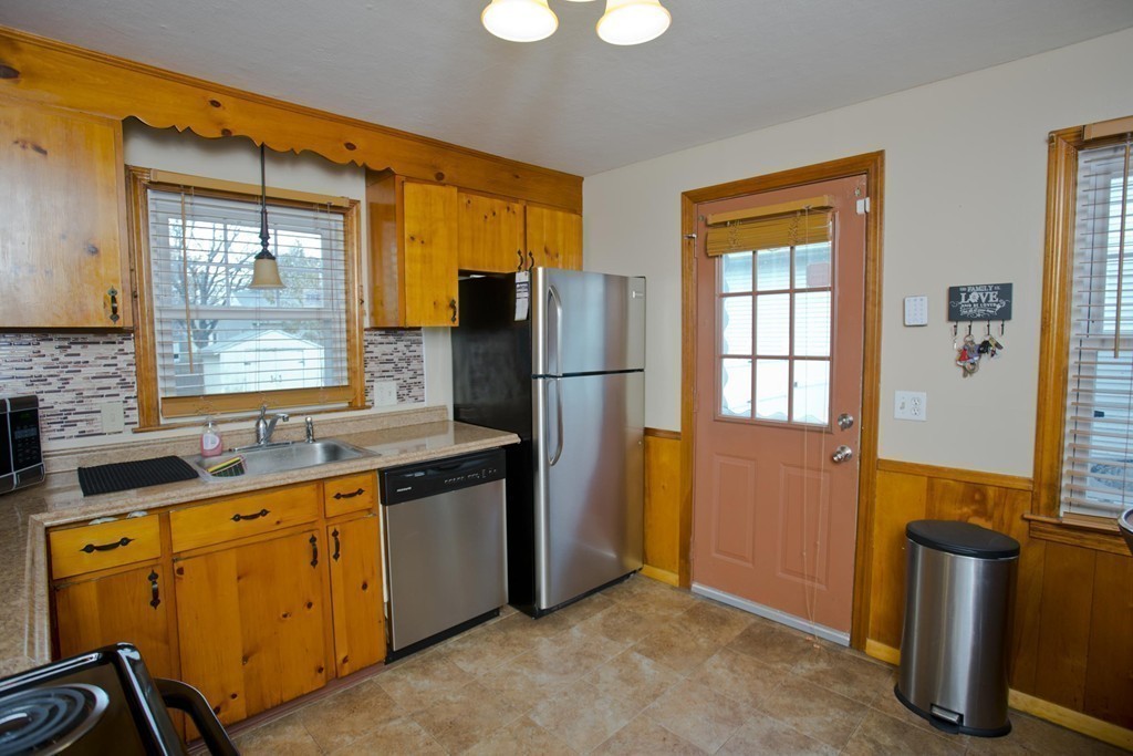 14 French Street Springfield, MA 01104 - Photo 14 of 29 a kitchen with stainless steel appliances granite countertop a refrigerator a sink dishwasher a stove and a dining table with wooden floor