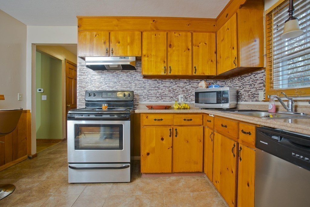 14 French Street Springfield, MA 01104 - Photo 16 of 29 a kitchen with stainless steel appliances granite countertop a stove and cabinets