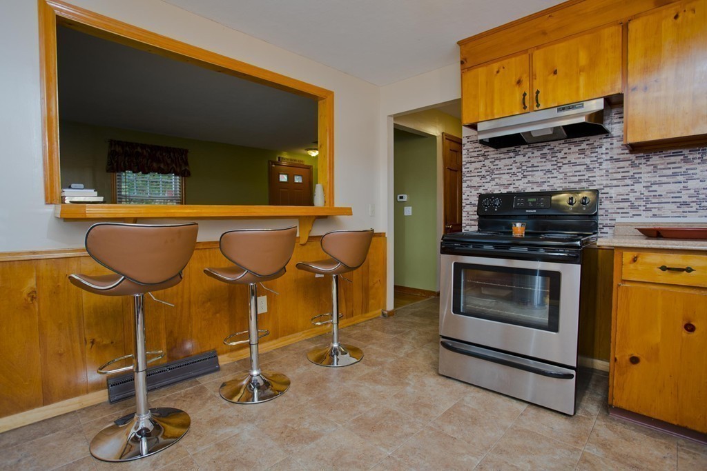 14 French Street Springfield, MA 01104 - Photo 17 of 29 a kitchen with granite countertop a stove and a fireplace