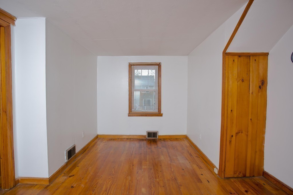 14 French Street Springfield, MA 01104 - Photo 18 of 29 a view of an empty room with wooden floor and a window