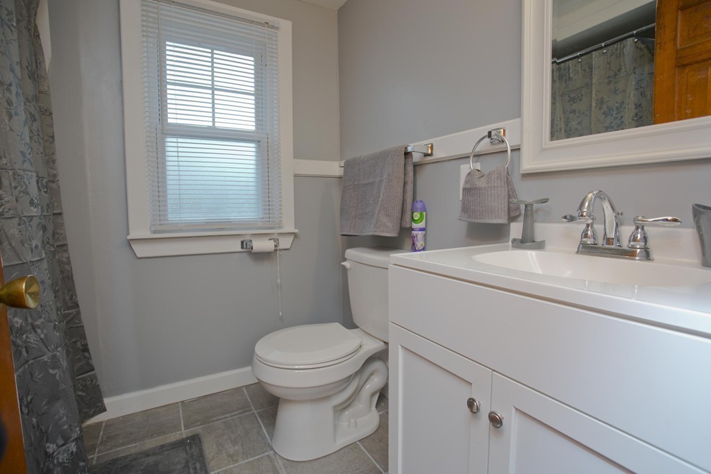 14 French Street Springfield, MA 01104 - Photo 21 of 29 a bathroom with a toilet sink vanity and mirror