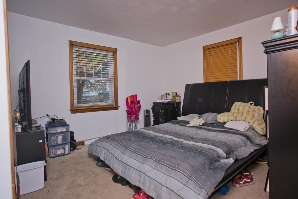 14 French Street Springfield, MA 01104 - Photo 29 of 29 a bedroom with a bed and wooden floor