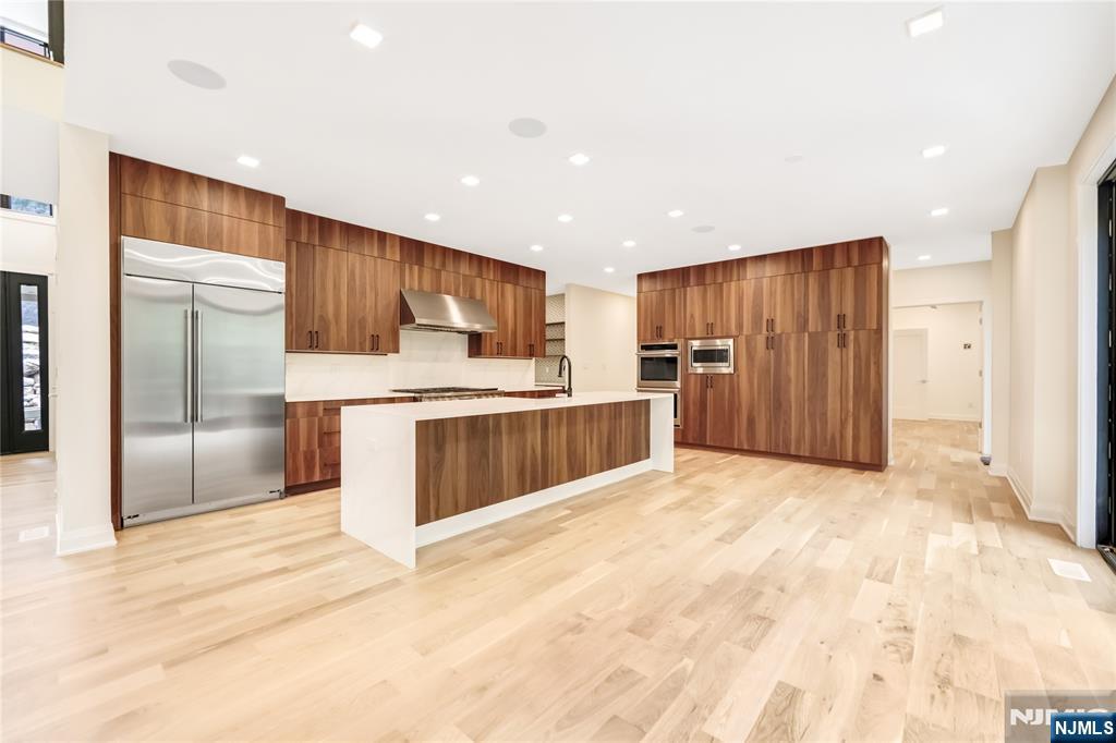 10 Big Ramapo Road Saddle River, NJ 07458 - Photo 13 of 44 a large kitchen with a refrigerator and a stove top oven