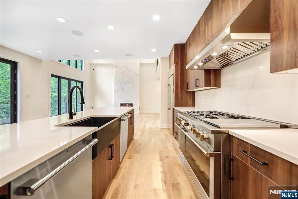 10 Big Ramapo Road Saddle River, NJ 07458 - Photo 14 of 44 a kitchen with stainless steel appliances granite countertop a sink a stove and a refrigerator