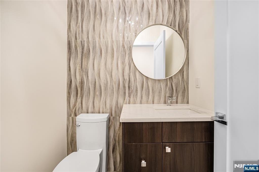 10 Big Ramapo Road Saddle River, NJ 07458 - Photo 20 of 44 a bathroom with a sink a toilet and a mirror