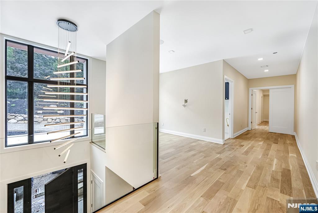 10 Big Ramapo Road Saddle River, NJ 07458 - Photo 27 of 44 a view of empty room with wooden floor and fan