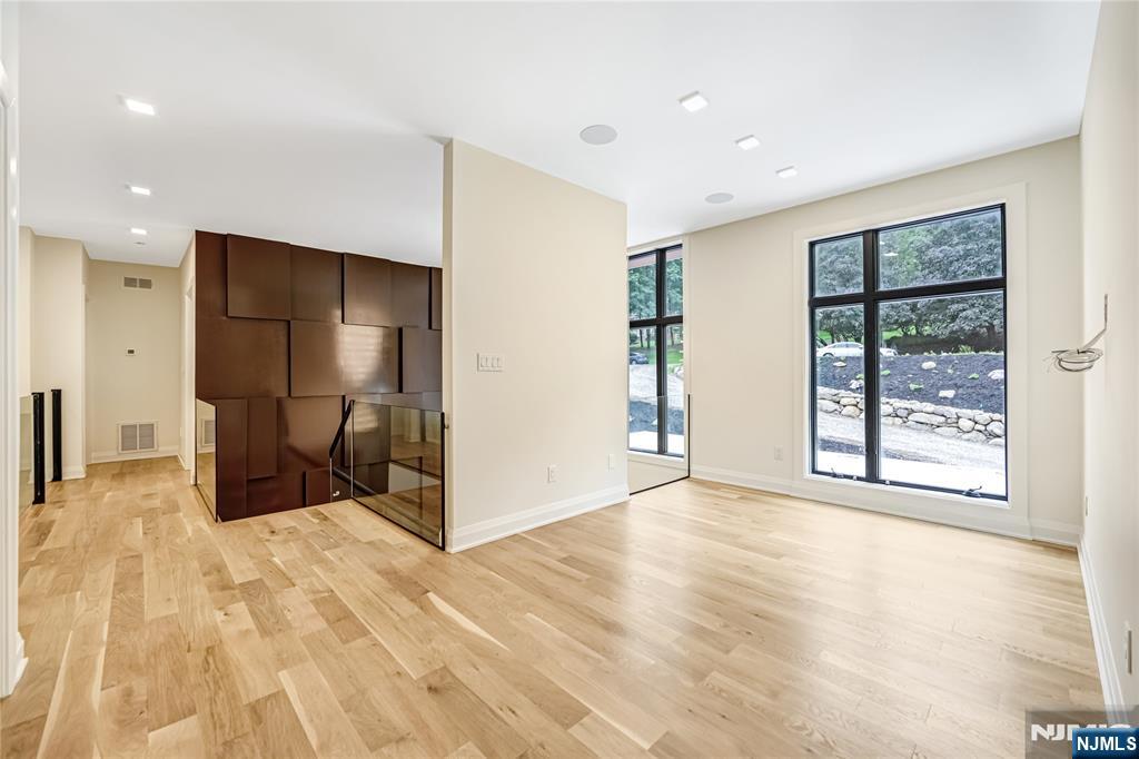 10 Big Ramapo Road Saddle River, NJ 07458 - Photo 29 of 44 a view of an empty room with wooden floor and a window