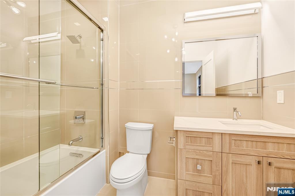 10 Big Ramapo Road Saddle River, NJ 07458 - Photo 32 of 44 a bathroom with a sink toilet vanity and shower