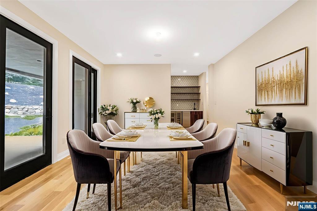 10 Big Ramapo Road Saddle River, NJ 07458 - Photo 7 of 44 a view of a dining room with furniture and wooden floor